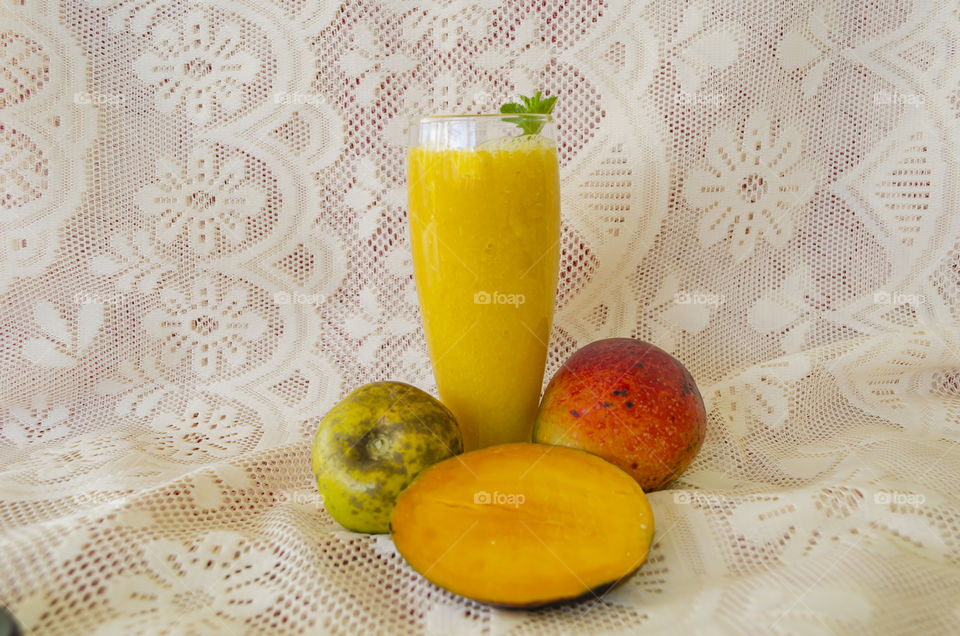 Glass Filled With Juice Made From Mango and White Spapote