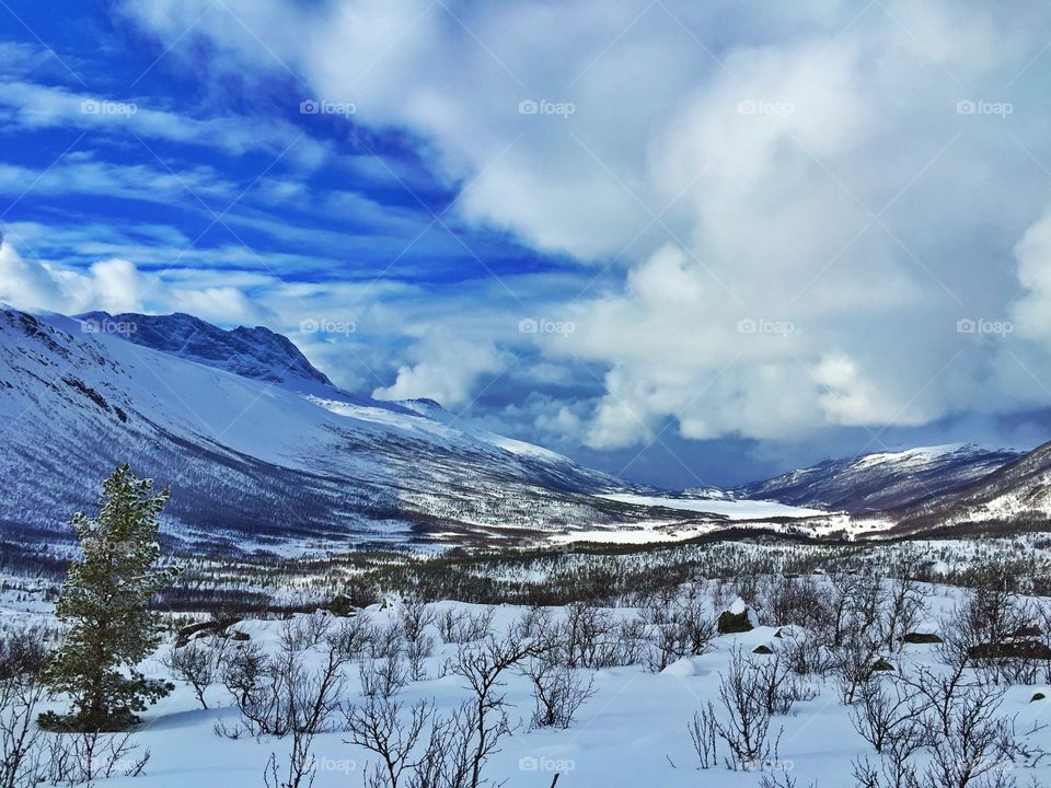 Mountain range against cloudy sky