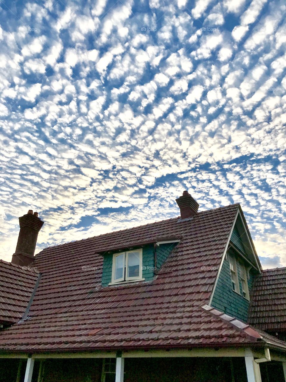 Clouds over red tiled roof and chimneys, Newcastle Australia 