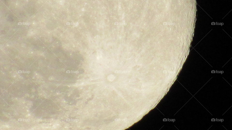 Close up of a large crater on the full moon
