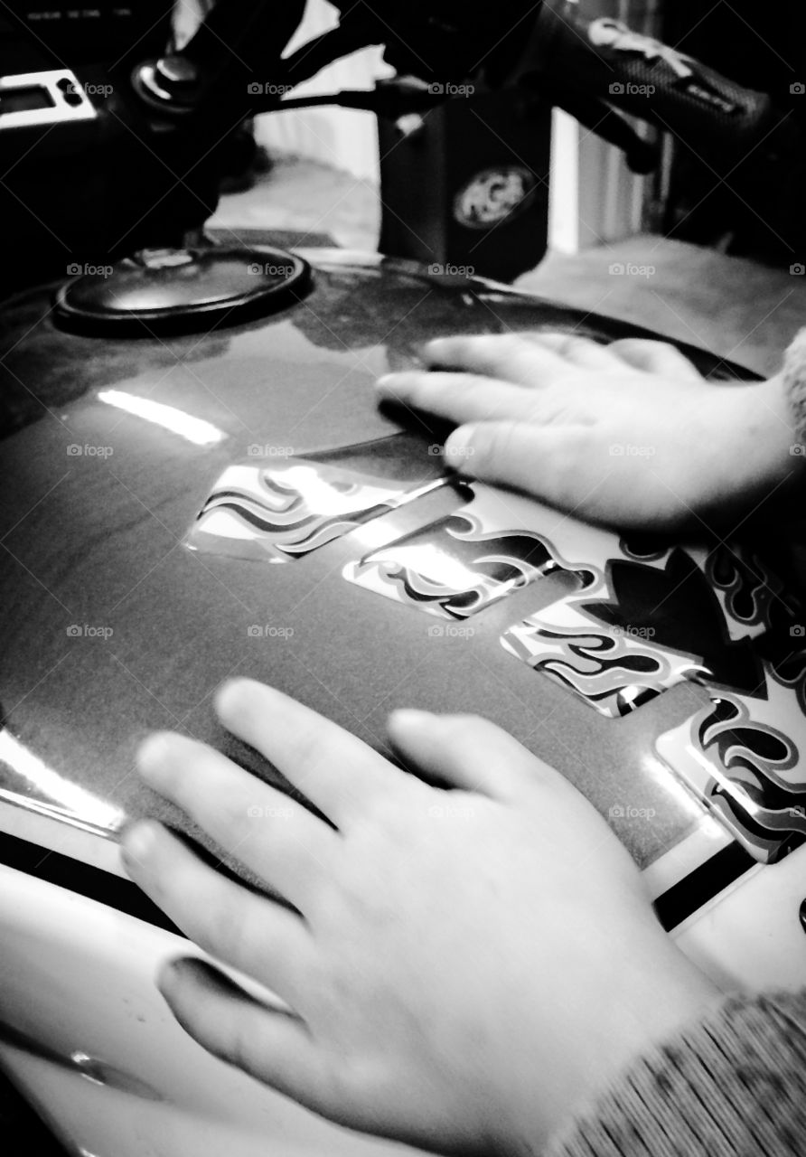 Little boys hands. Sitting on the motorcycle