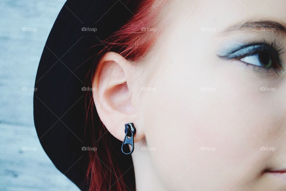 Woman's ear with zip earring