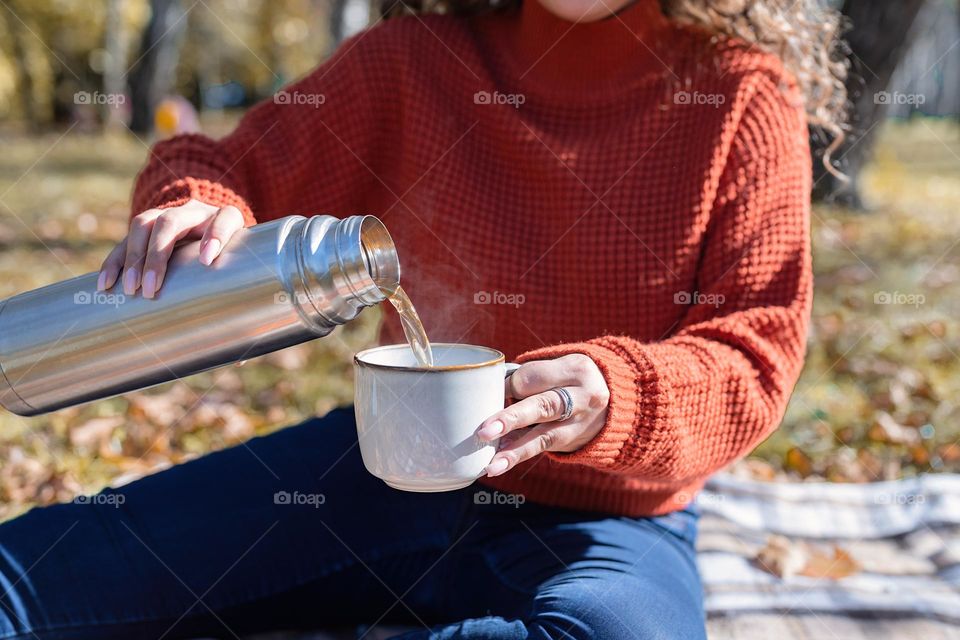 woman in sweater drinking tea