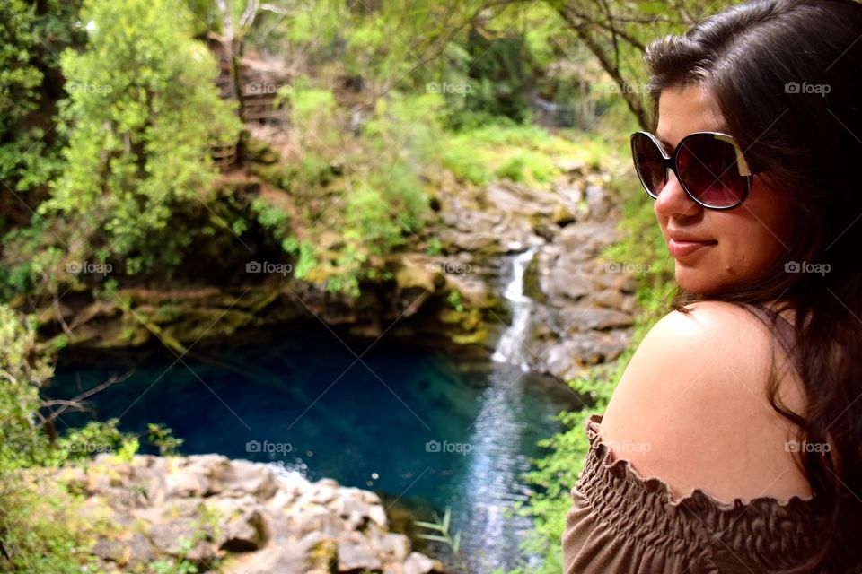 Beautiful girl enjoying Caburgua Waterfalls