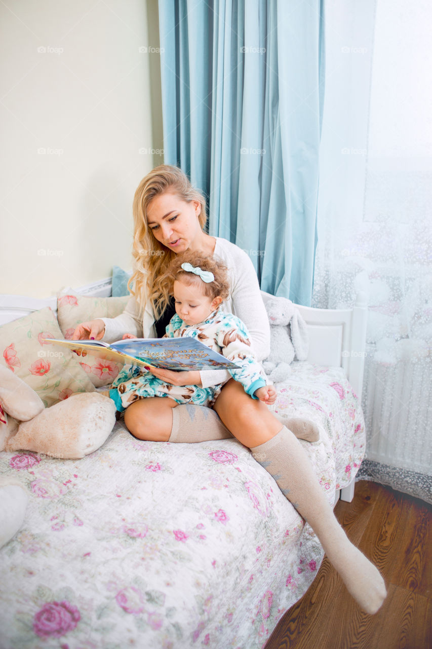 Mother with daughter reading a book