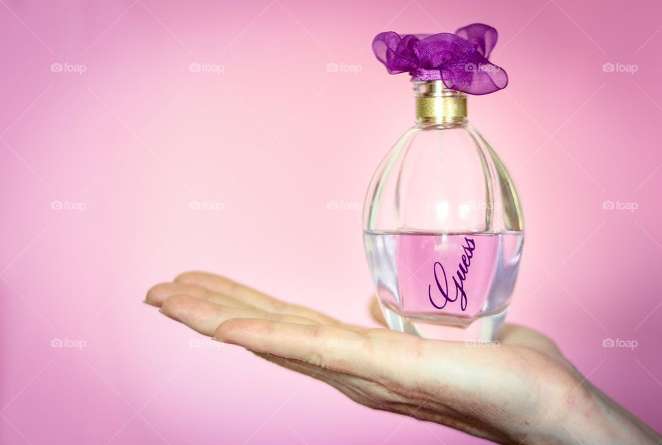 Guess parfume on a palm of a hand