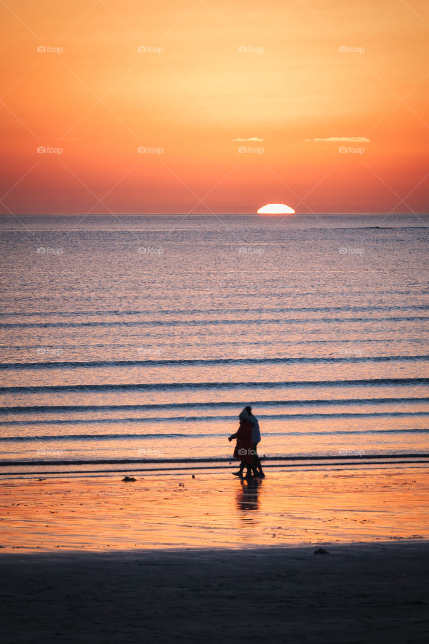 Walking in sunset at Silverstrand beach, Galway, Ireland