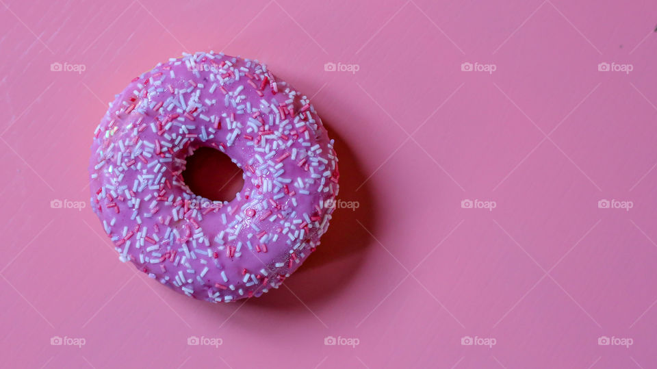 Pink donut on the pink background 