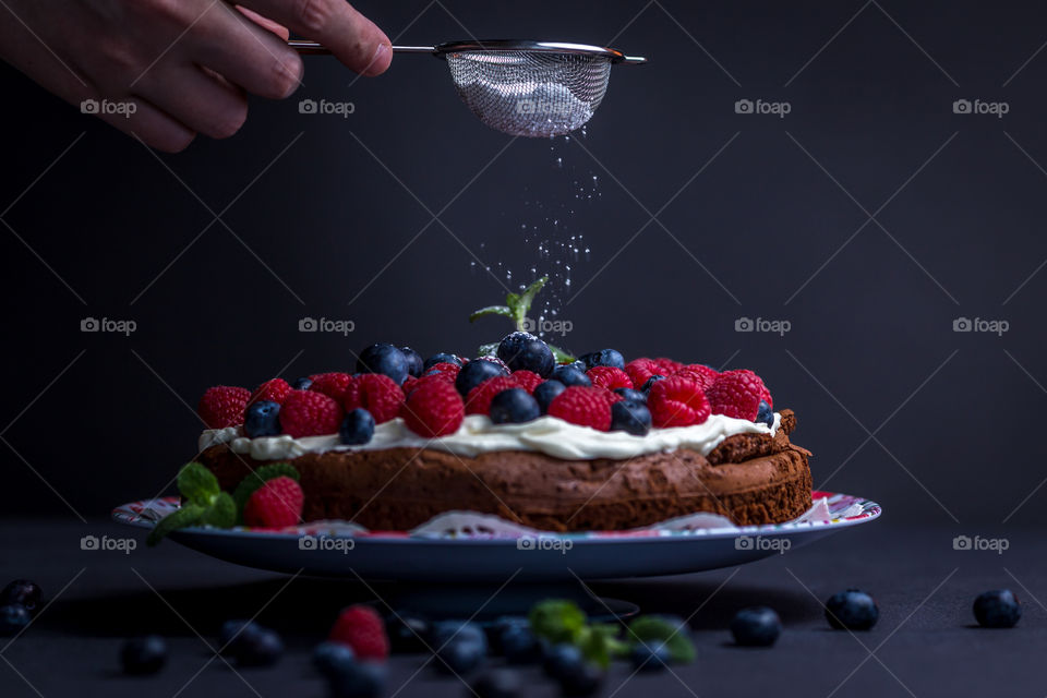 A human preparing cake