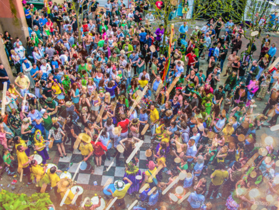 The view from up above a large crowd on people dancing and celebrating at a local town event