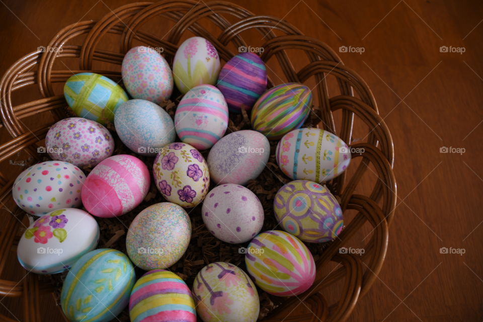 Easter eggs  hand-painted by me in basket on wooden table