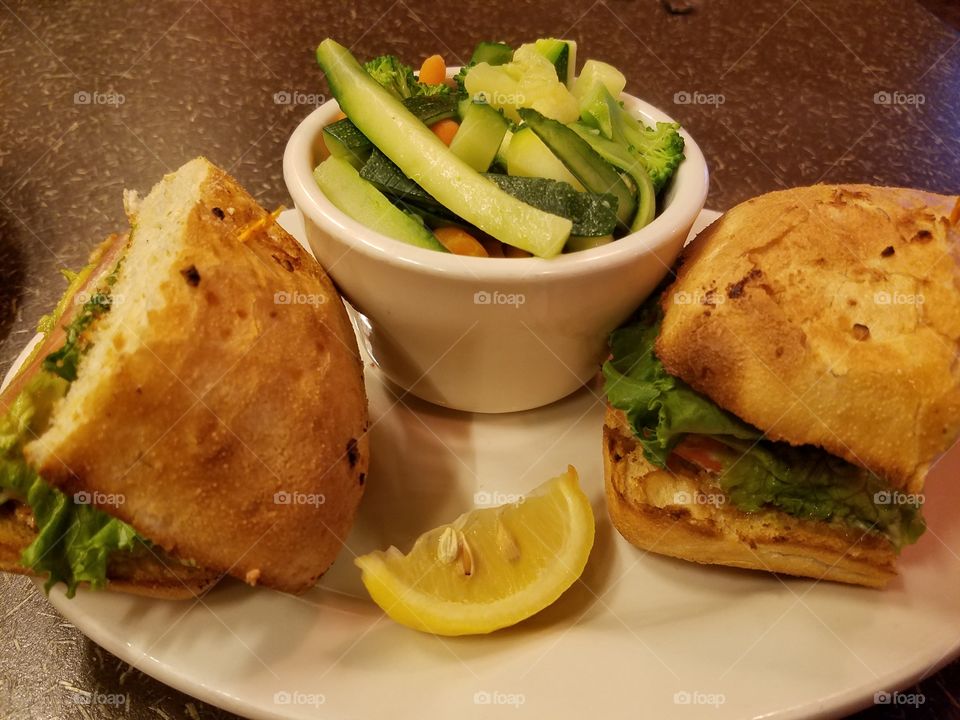 Delicious sandwich with salmon, guacamole, lettuce and tomato