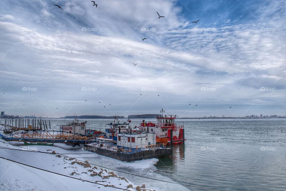 Docks in winter season on river background