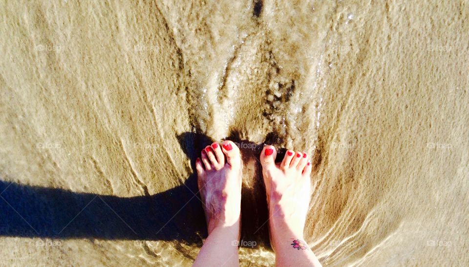 Summer getaway. Sun on my face, feet in the sand 