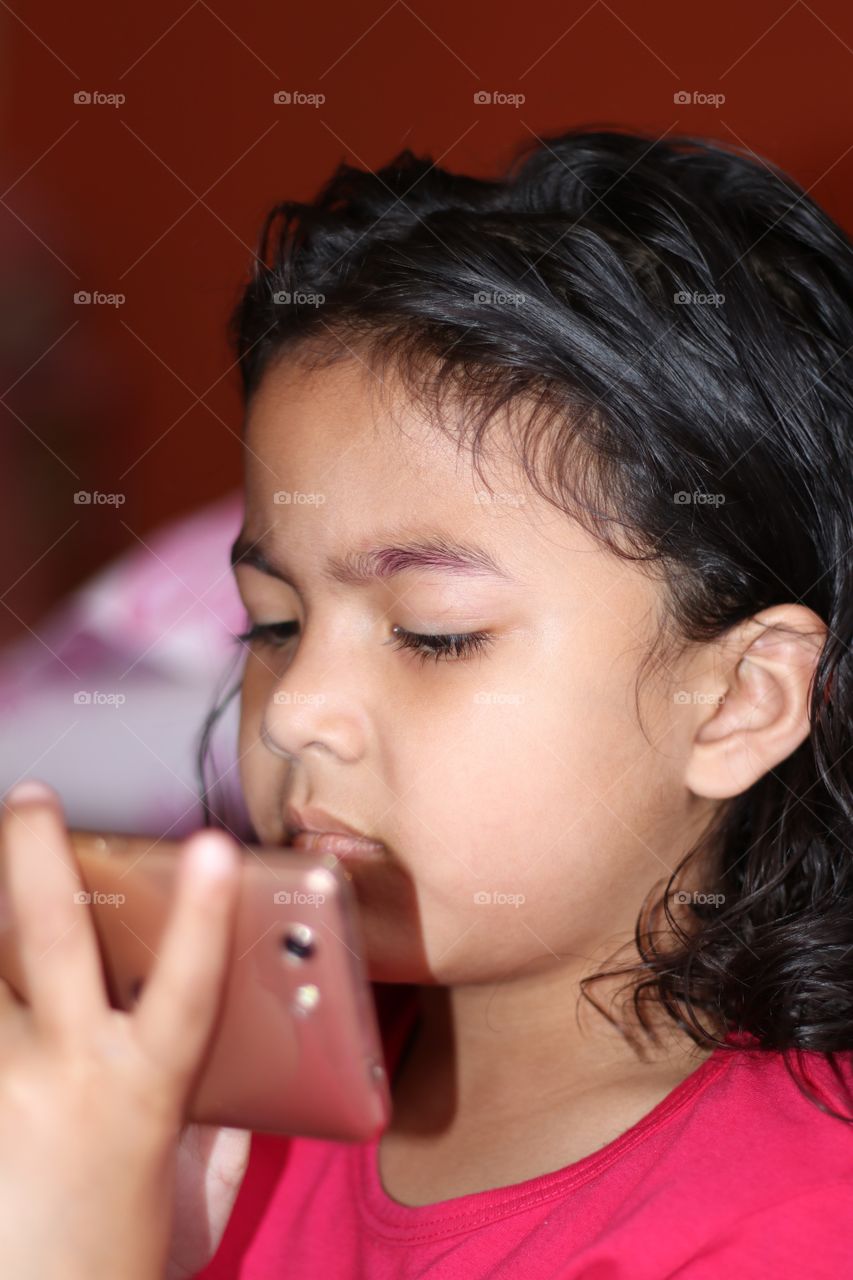 kid watching mobile phone