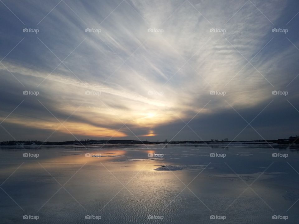 sun set over frozen water
