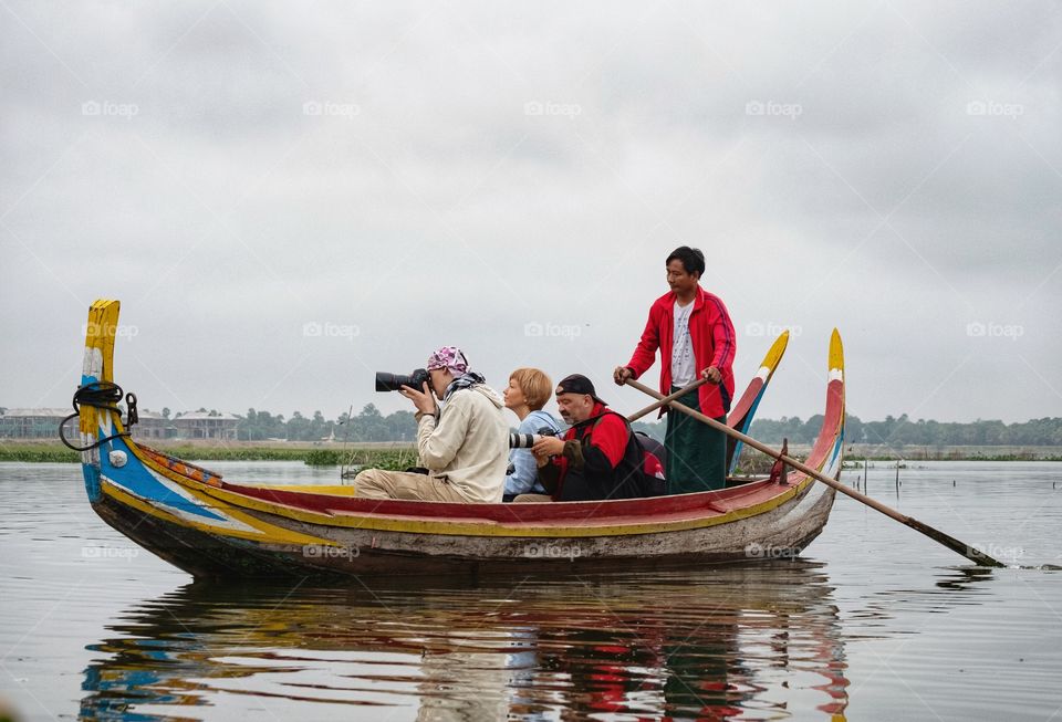 Photographer is taking local fishermen photo in U-bein the longest wooden bridge at Mandalay Myanmar 