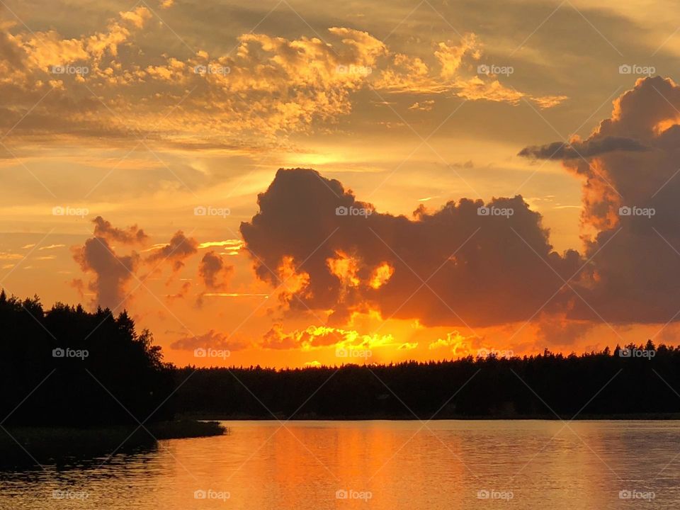 Beautiful tranquil dramatic sunset landscape over the mirror smooth sea water surface 