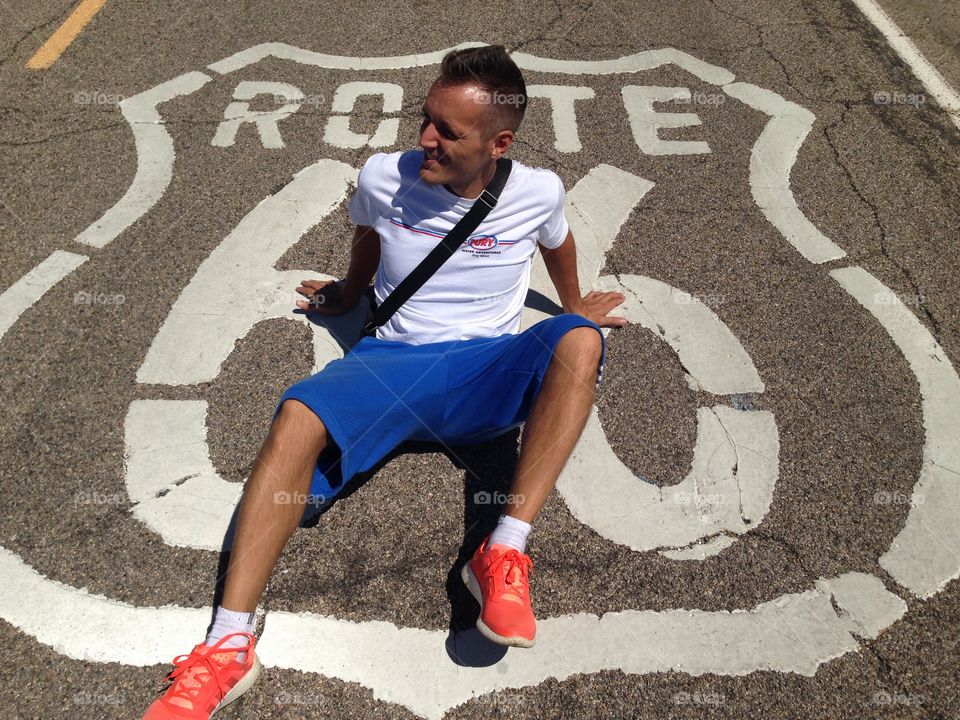 Man on road with route 66 sign