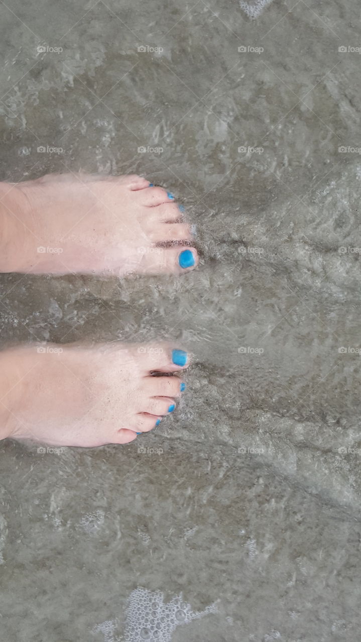 Rushing water over my feet. enjoying some time on vacation.