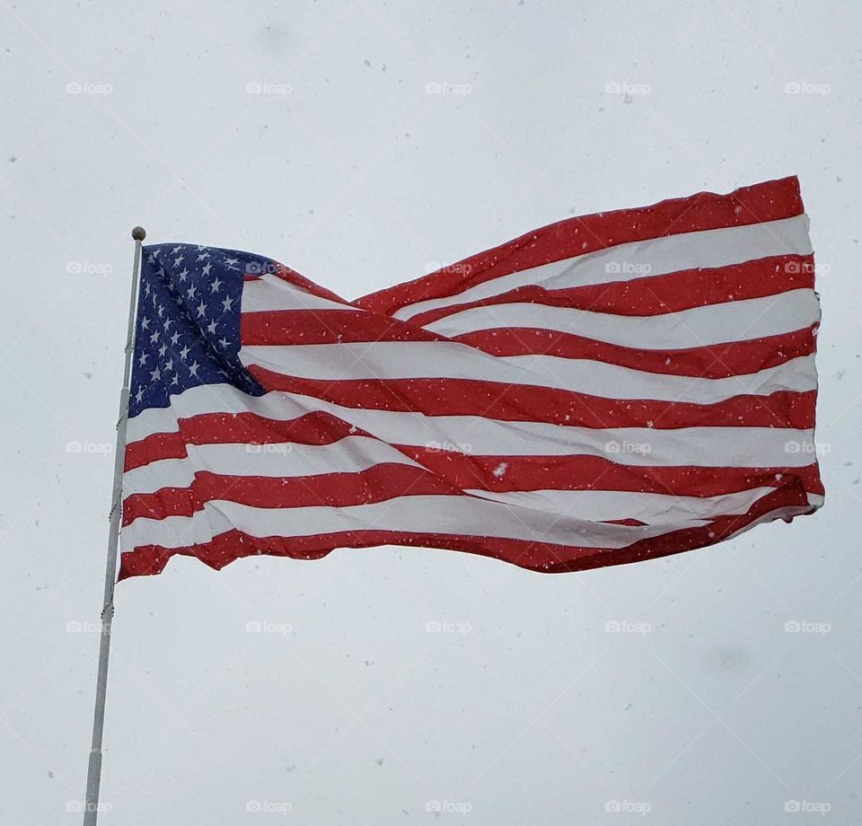 big flag blowing on winter day