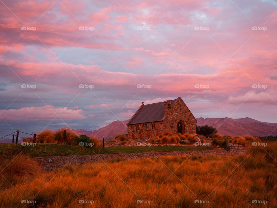 The Church of the Good Shepherd in a rural New Zealand town as the sunset casts a fiery sky