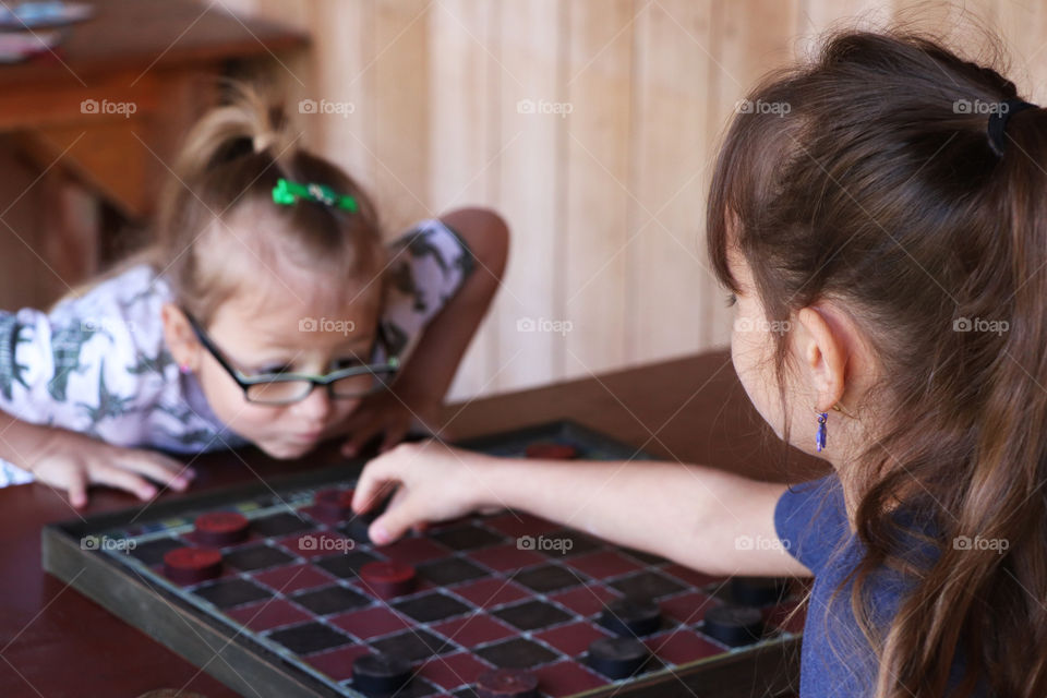 Two children playing checkers