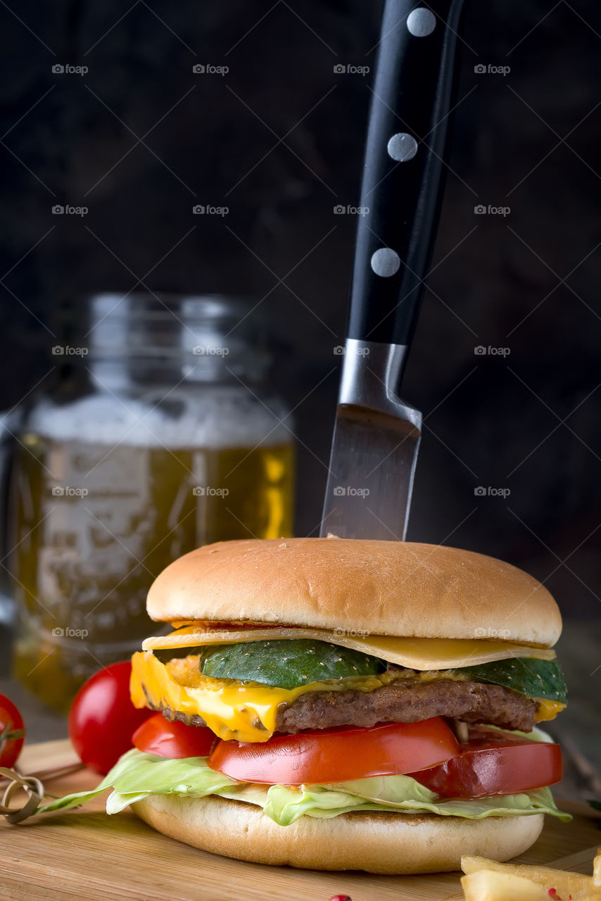 homemade cheeseburger  with salad, tomato and beef