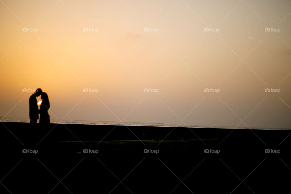 Silhouette of couple standing during sunset