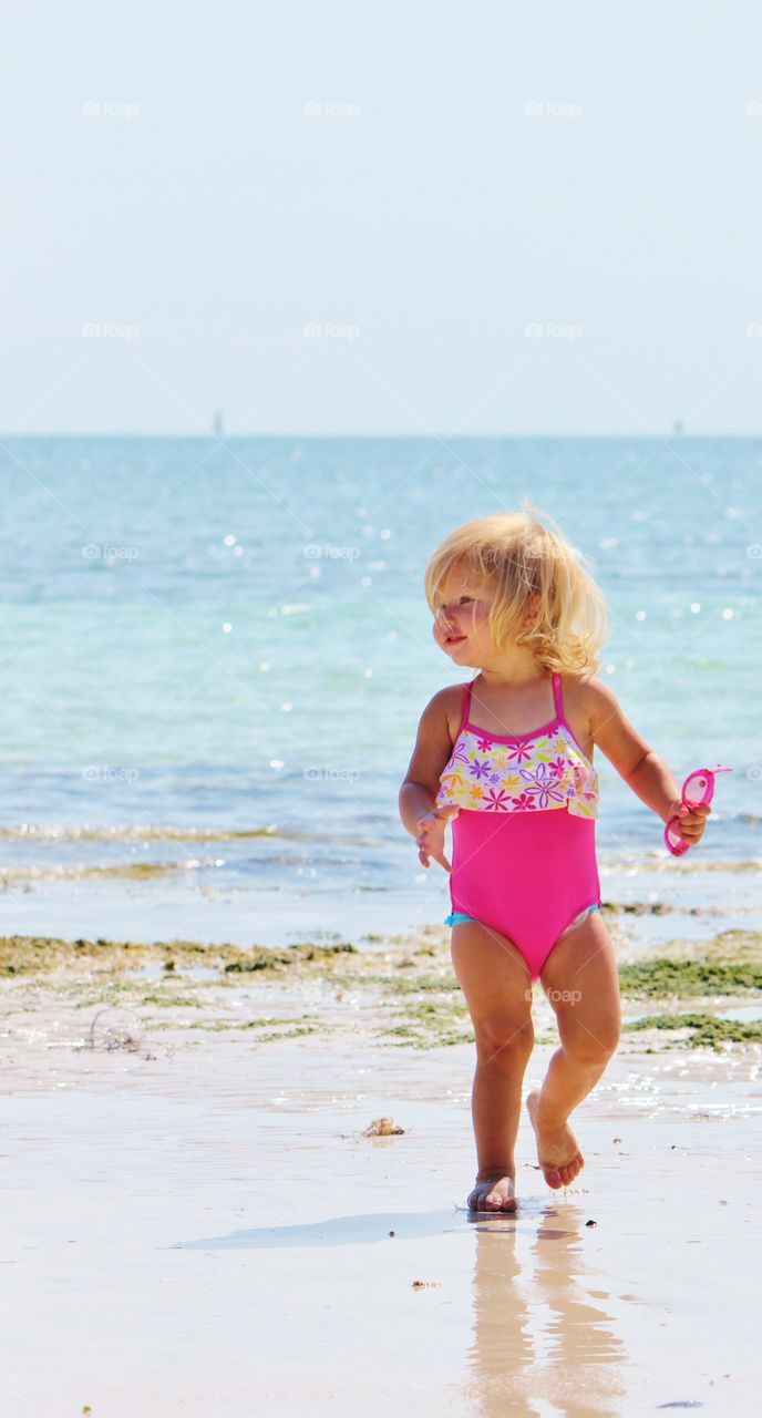 Little girl at play at the beach