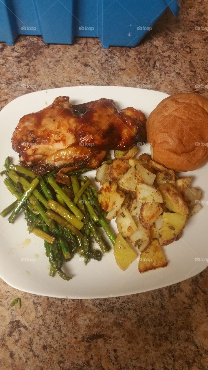 barbecue chicken, pan seared asparagus, roasted potatoes and a dinner roll