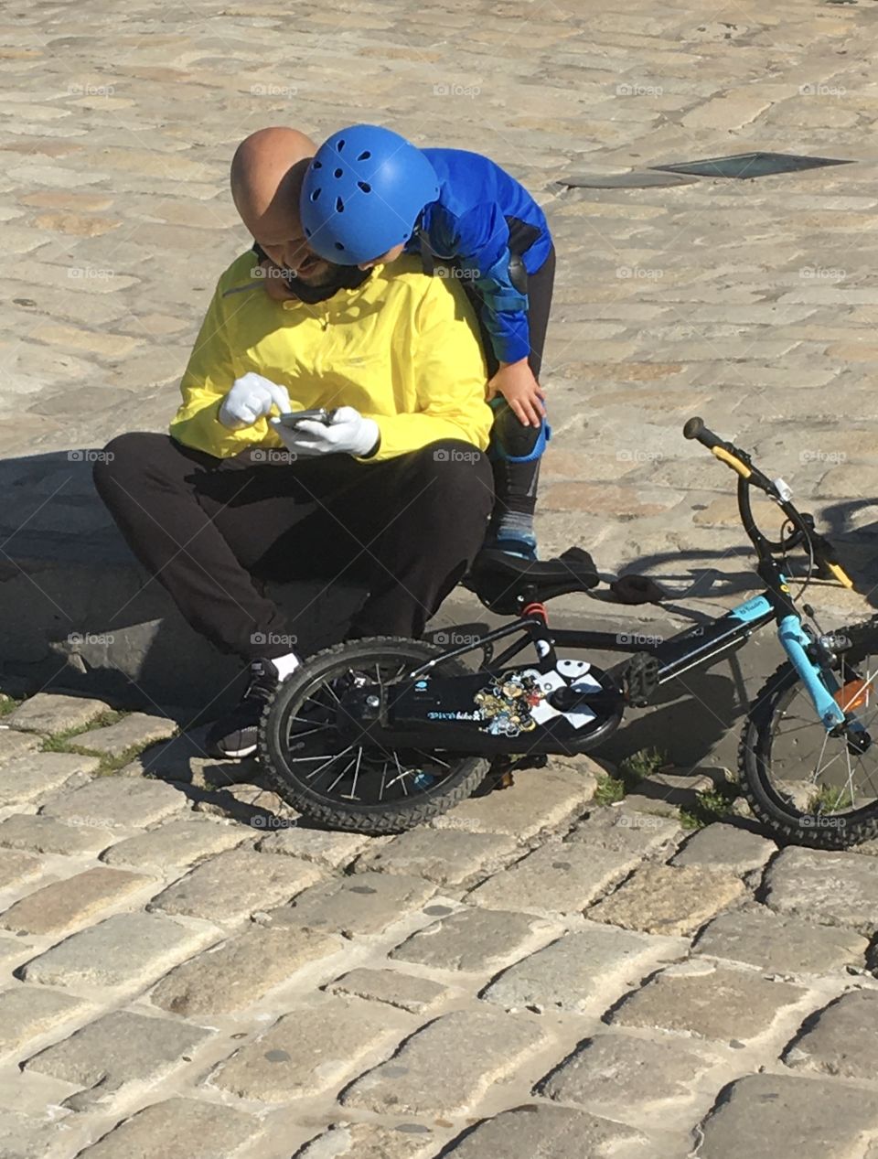 Kid with helmet, bicycle and father !