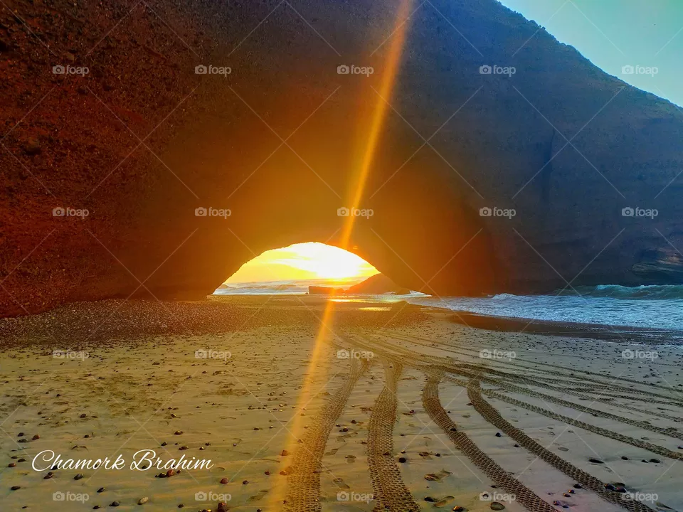 Beautiful sunset below the arch of Elghzira in the region of Ifni,Morocco.
the photo was taken in 7/11/2020