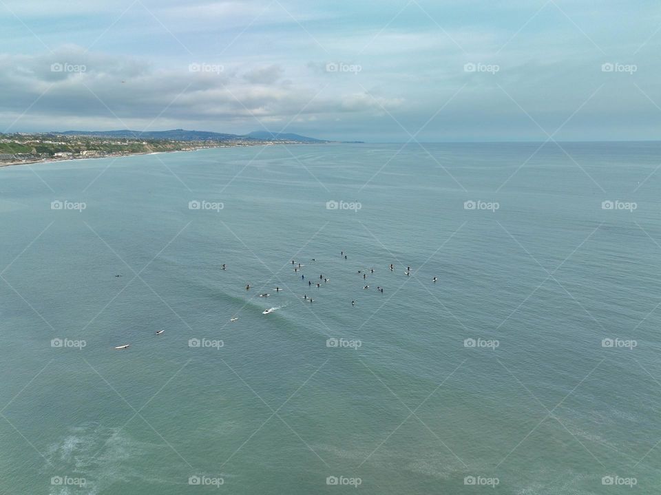 A group of surfers set out from Laguna Beach to catch some great waves in sunny Southern California 