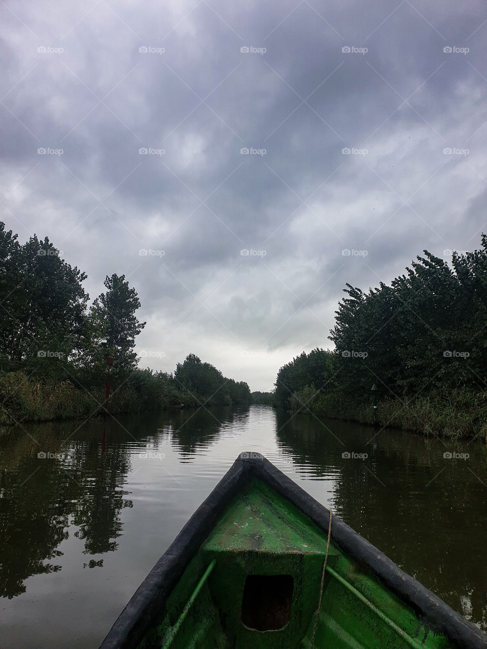 Sailing a boat on a calm lake.