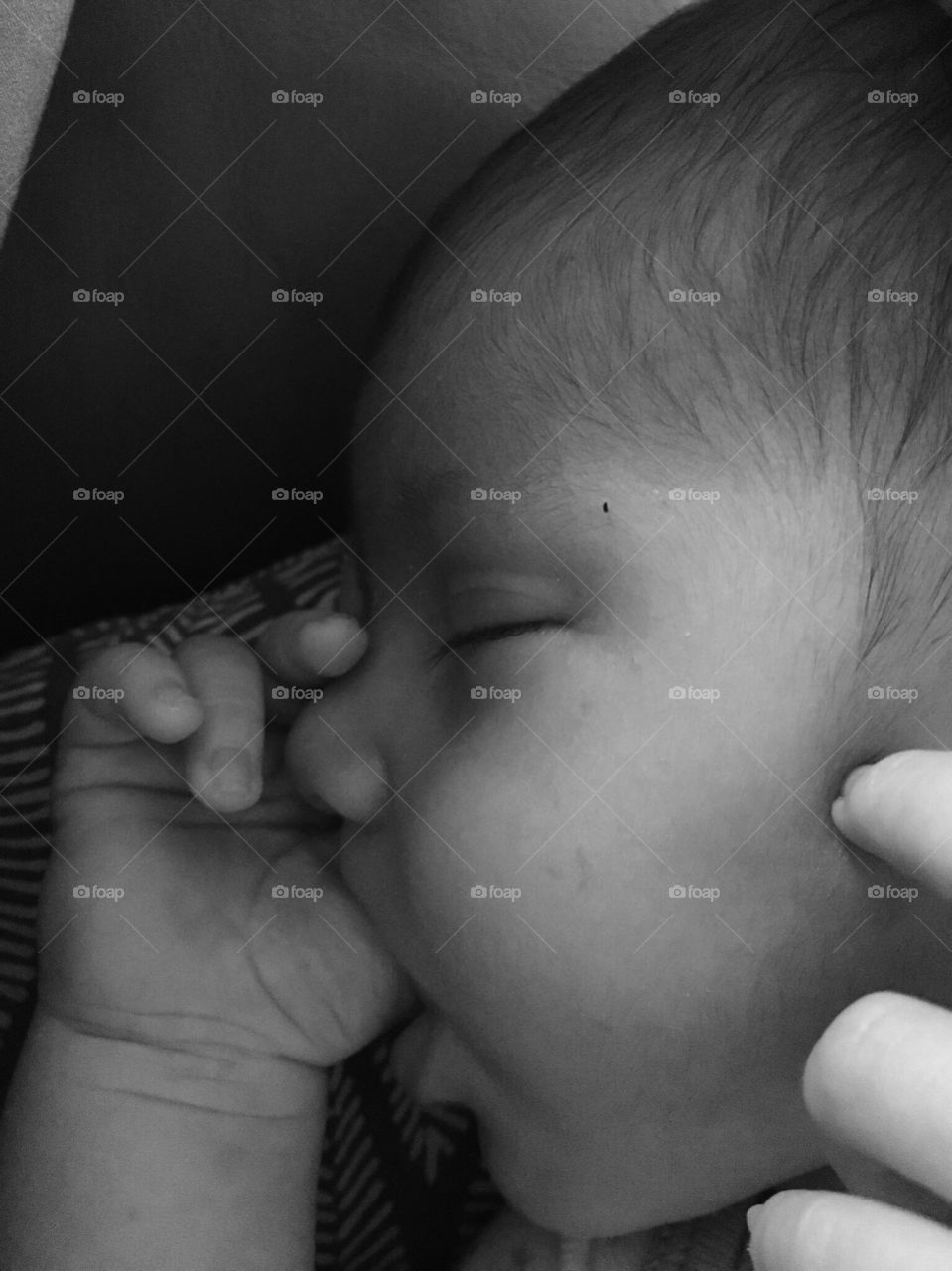Infant sucking thumb.