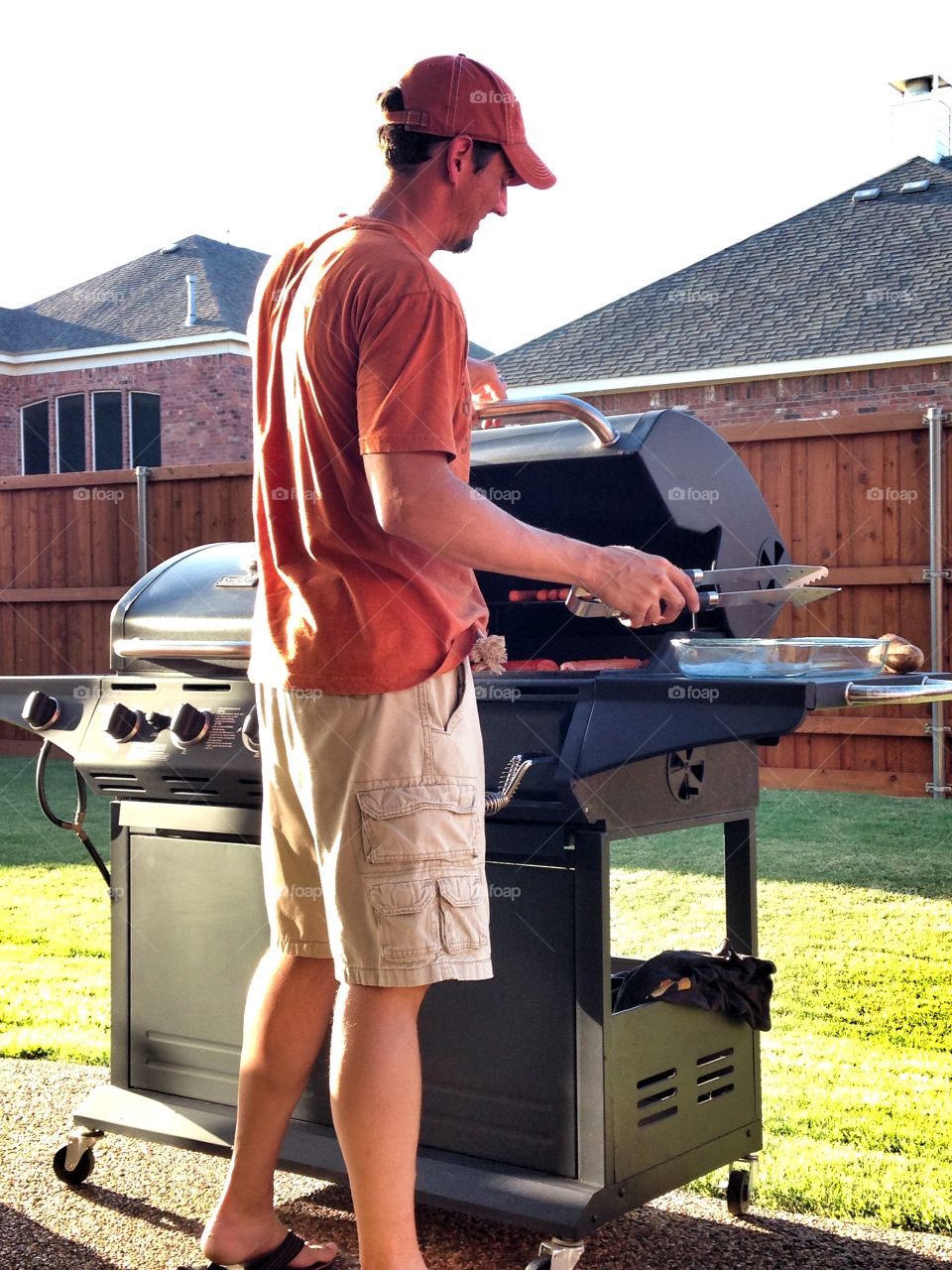 Man preparing food on barbeque grill
