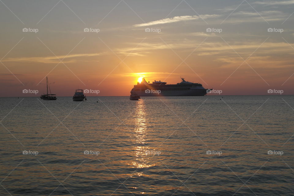 A carribean cruise ship sailung in Sunset 