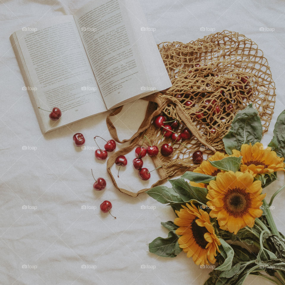 book, sunflowers and cherries