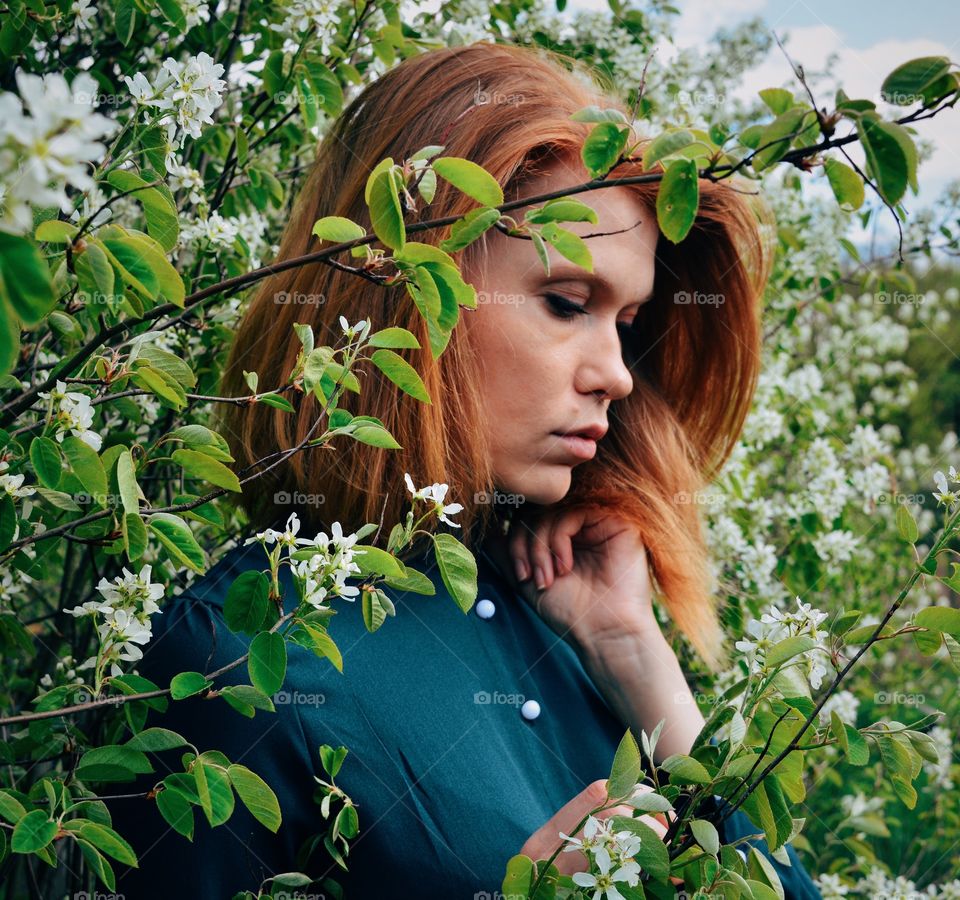 Woman standing near flower tree