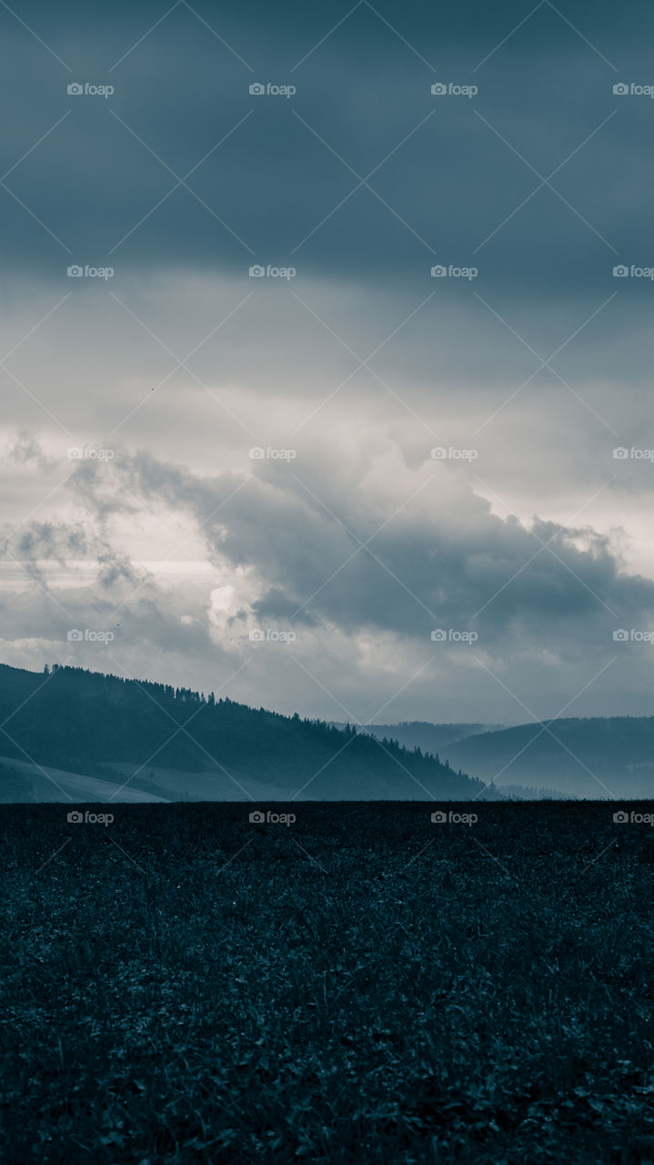 An inspiring mountain landscape. Tatry mountains in Slovakia. A beautiful wallpaper for smartphone screen. Monochrome blue abstract gradient with perspective.