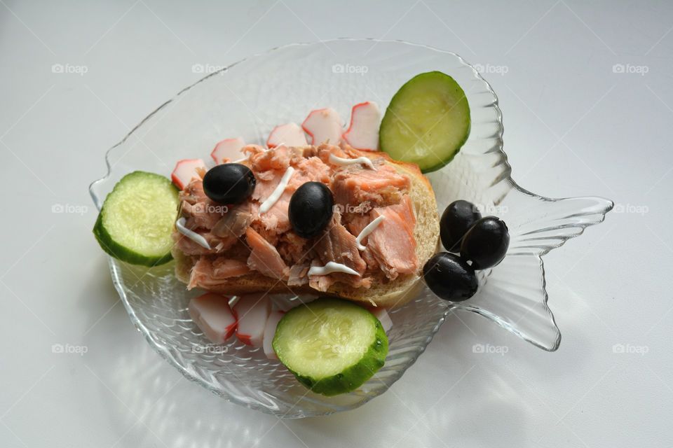 sandwich with red fish and vegetables on a plate