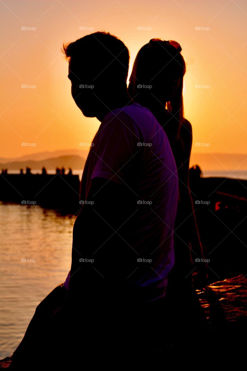 Young couple in sunset at Chania old port, Crete