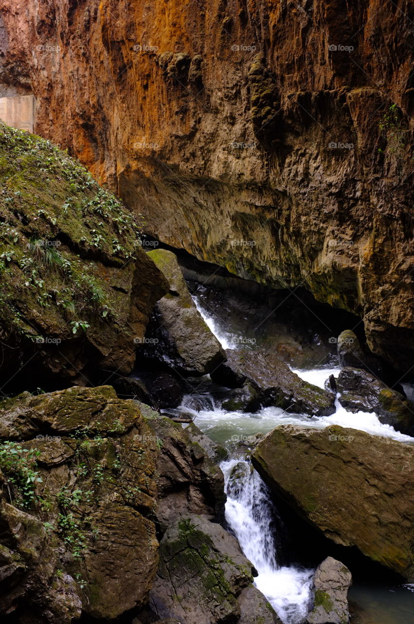 Stream flowing through rocky mountain