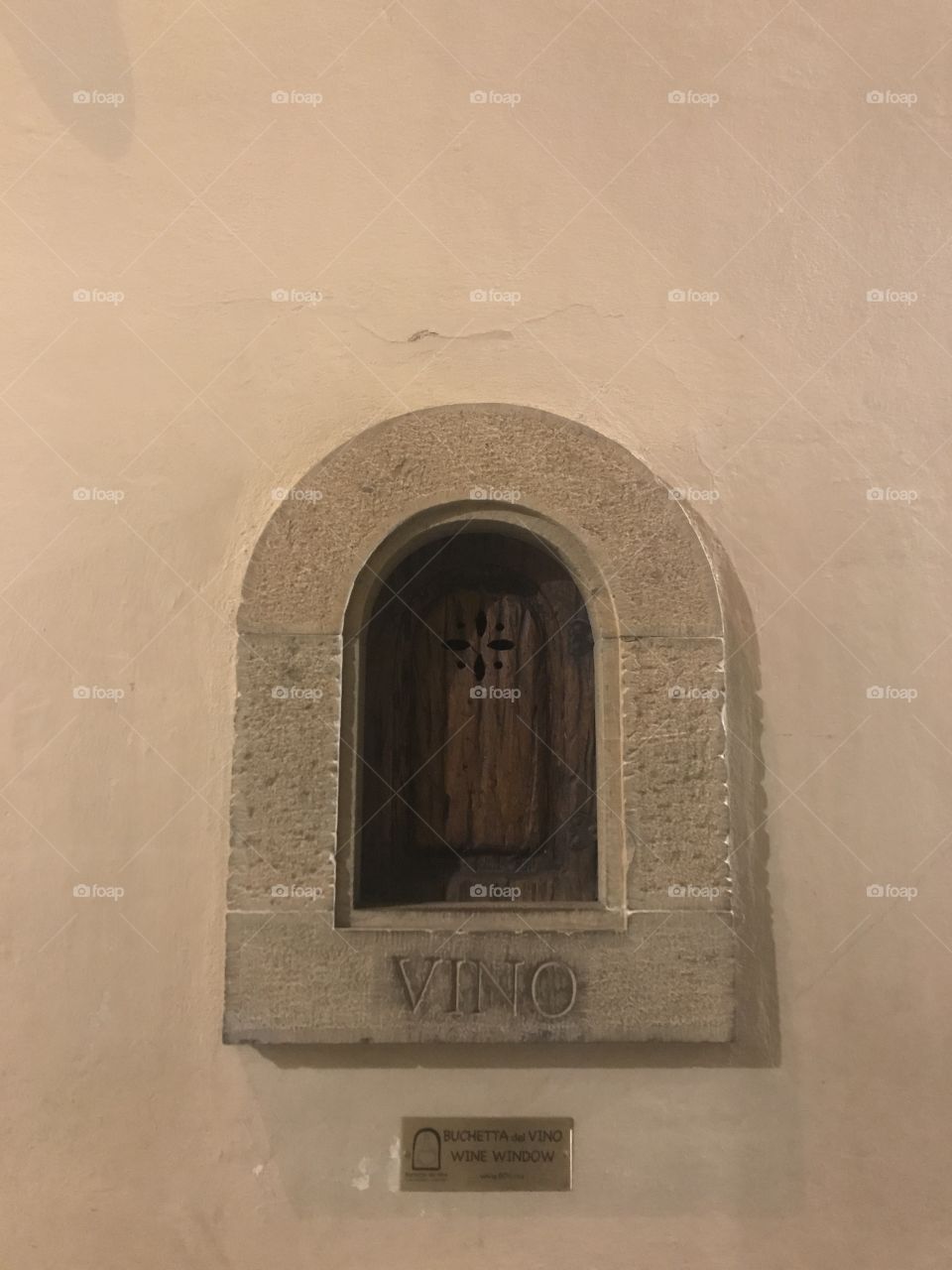 Cute little wine box inside a wall of a restaurant in Florence, Italy.