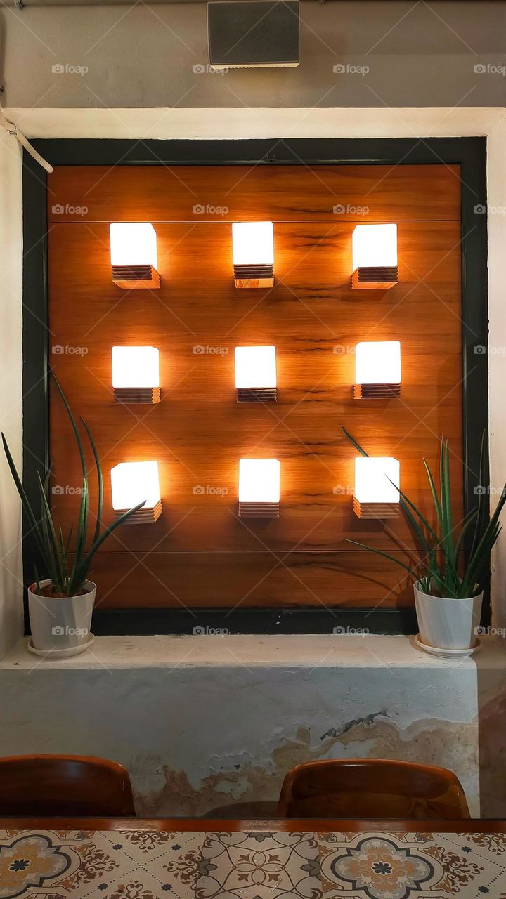 Decorative lights arranged neatly and beautifully on a wall as ornament and room decoration.