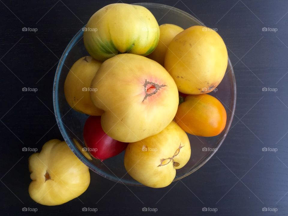 Tomatoes in the bowl on the table