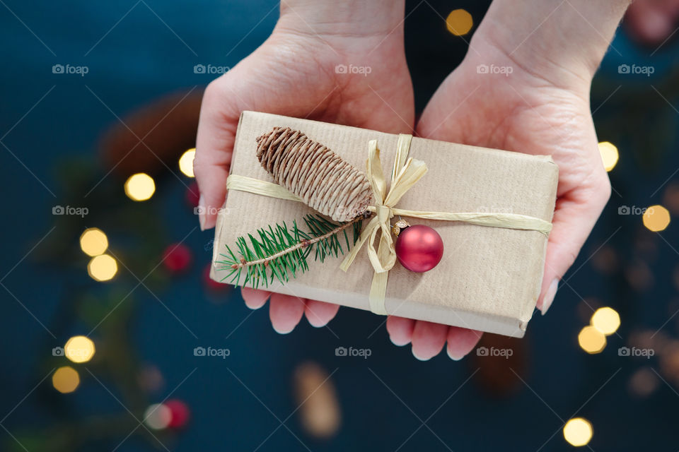 Christmas present. Woman holding Christmas present