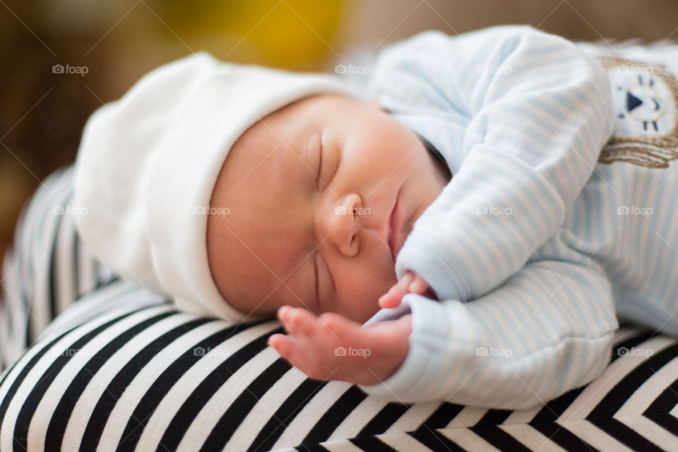 Newborn baby boy sleeping on his side 