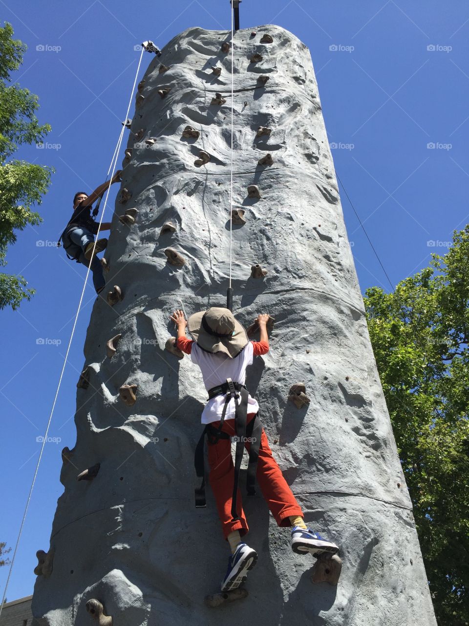 Children rock climbing on a rock wall